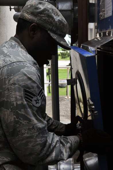 KUNSAN AIR BASE, Republic of Korea -- Senior Airman Edgar Denard, 8th Civil Engineer Squadron heating, ventilating, air conditioning and refrigerating technician, performs system maintenance here Aug. 4. HVAC Airmen maintain 1.7K HVAC/R Systems base wide and assist Army with specialized air conditioning equipment. (U.S. Air Force photo/Senior Airman Brittany Y. Bateman) 