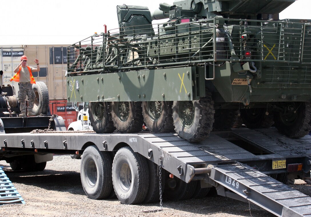 Army Pvt. Tyler Duke guides a Stryker armored vehicle onto the bed of a trailer truck in Kuwait, Aug. 26, 2010, for transport to the United States as part of the drawdown of U.S. forces in Iraq. U.S. Army photo by Sgt. Sean Patrick Casey