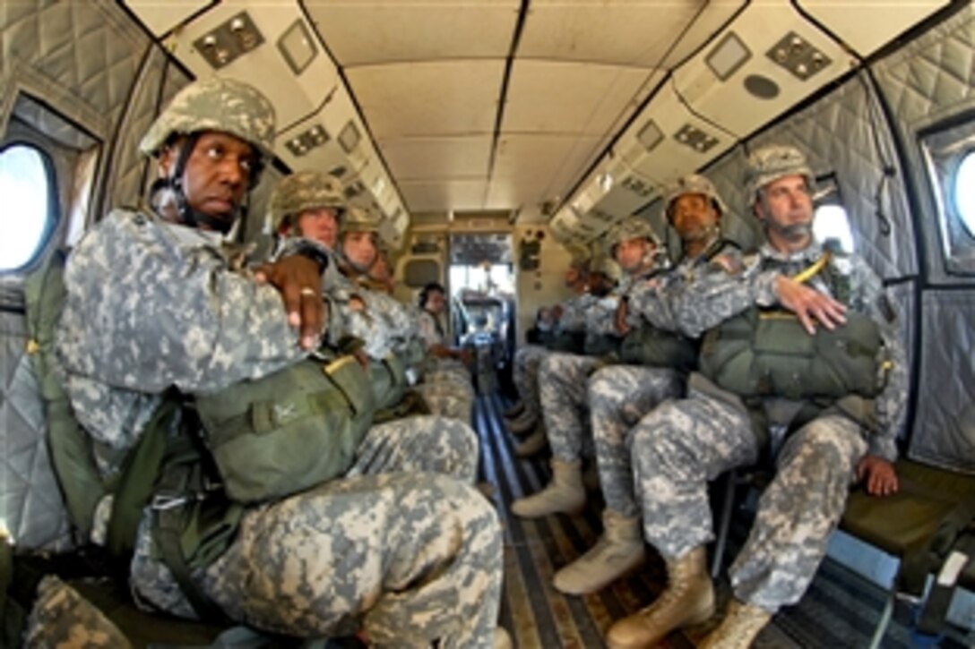 Army Col. Christopher Sharpton, right, and members of his staff wait to jump from a Casa 212 aircraft during an airborne operation over the St. Mere Eglise drop zone on Fort Bragg, N.C., Aug. 2, 2011. Sharpton is the 82nd Sustainment Brigade commander.