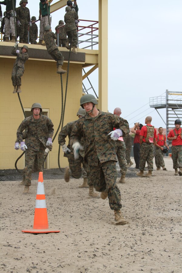 Recruits hit the ground running after fast roping Aug. 5. They learned how to fast rope before they received their classes on how to rappel and make their harness. Fast roping is a method of quick insertion on an objective from a helicopter