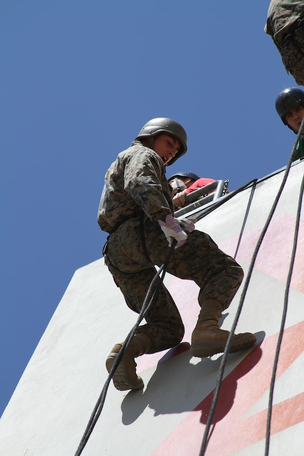 A recruit from Company C begins his descent down a 60-foot rappel tower Aug. 5 aboard Marine Corps Recruit Depot San Diego. Drill instructors watch the recruits from above and below to ensure their safety.
