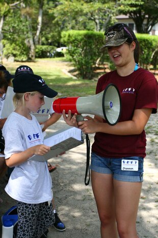 Shannon Gilbert, 16, and Sabrina Herritt, 10, teach other children about the dangers of peer pressure at the Kintai Park::r::::n::Aug. 5. They taught that peer pressure includes drugs, drinking alcohol, ditching school, and other things.