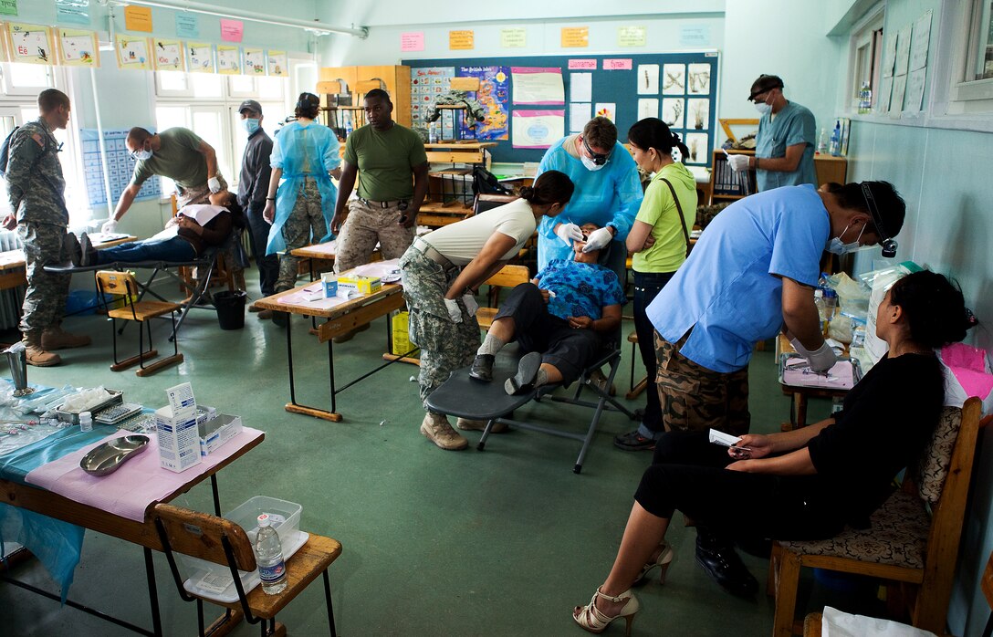 Dentists, assistants, patients and interpreters fill an elementary school classroom turned dental clinic during the Medical and Dental Civic Action Program of Exercise Khaan Quest 2011 in Ulaanbaatar, Mongolia, Aug. 7. Medical personnel from Mongolia, Canada, India, Korea and the U.S. shared their expertise to provide medical and dental care for hundreds of Mongolian citizens daily. Khaan Quest is a training exercise designed to strengthen the capabilities of U.S., Mongolian and other participating nations’ forces in international peace support operations worldwide.