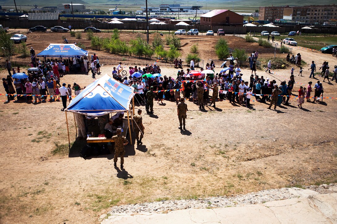 Mongolian citizens line the waiting area outside a local elementary school in the 9th khoroo, Khaan-Uul District, Ulaanbaatar, Mongolia, during the medical and dental, civic action program of Exercise Khaan Quest 2011, Aug. 7. Medical personnel from Mongolia, Canada, India, Korea and the U.S. shared their expertise to provide medical and dental care for hundreds of Mongolian citizens daily. Khaan Quest is a training exercise designed to strengthen the capabilities of U.S., Mongolian and other participating nations’ forces in international peace support operations worldwide.