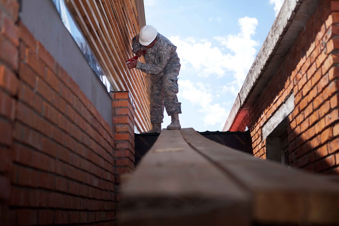 A soldier with 84th Battalion, 30th Brigade, 643rd Company out of Schofield Barracks, Hawaii, seals gaps along a wall during the Engineering Civic Action Program portion of Exercise Khaan Quest 2011 in Ulaanbaatar, Mongolia, Aug. 1. The purpose of the program is to improve medical care in the area by adding on to the Ayut Family Hospital, a 17,000 sq. ft. urgent care clinic, which will serve the 9th sub-district of khaan-Uul District. Khaan Quest is a training exercise designed to strengthen the capabilities of U.S., Mongolian and other participating nations’ forces in international peace support operations and civic outreach programs worldwide.