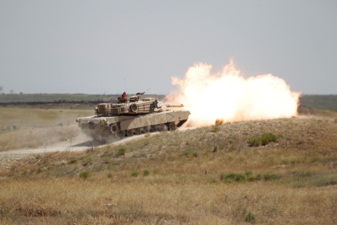 Tanks fire down range at the Tiger Competition at the 4th Tank Battalion Compound in Boise, Idaho Aug. 6, 2011. The competition included the best crew from every tank battalion in the Marine Corps to compete and represent their battalion.