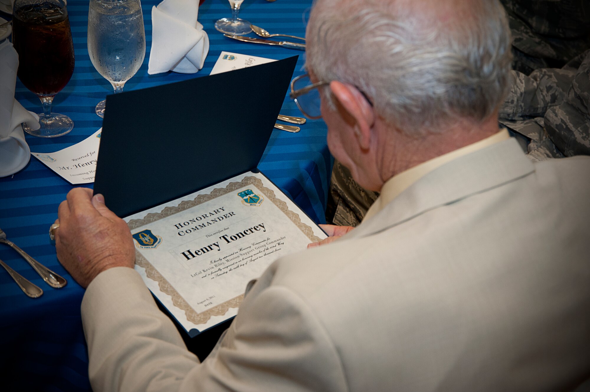 City of D'Iberville councilman, Henry Toncrey, looks at the certificate recognizing him as the 403rd Mission Support Group's new Honorary Commander. Toncrey and 13 other Gulf Coast civic leaders were inducted into the 403rd Wing's Honorary Commander program during a luncheon held in their honor Aug. 6. (U.S. Air Force Photo by Staff Sgt. Brent Skeen)