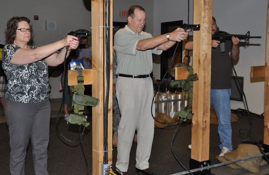 Employer's Day 2011 participants (from left to right) Elizabeth Honiotes, George Zirnhelt and Kevin Souther practice their shooting skills in the 934 Security Forces Squadron firearms training simulator.  (Air Force photo/Staff Sgt. Kimberly Hickey)