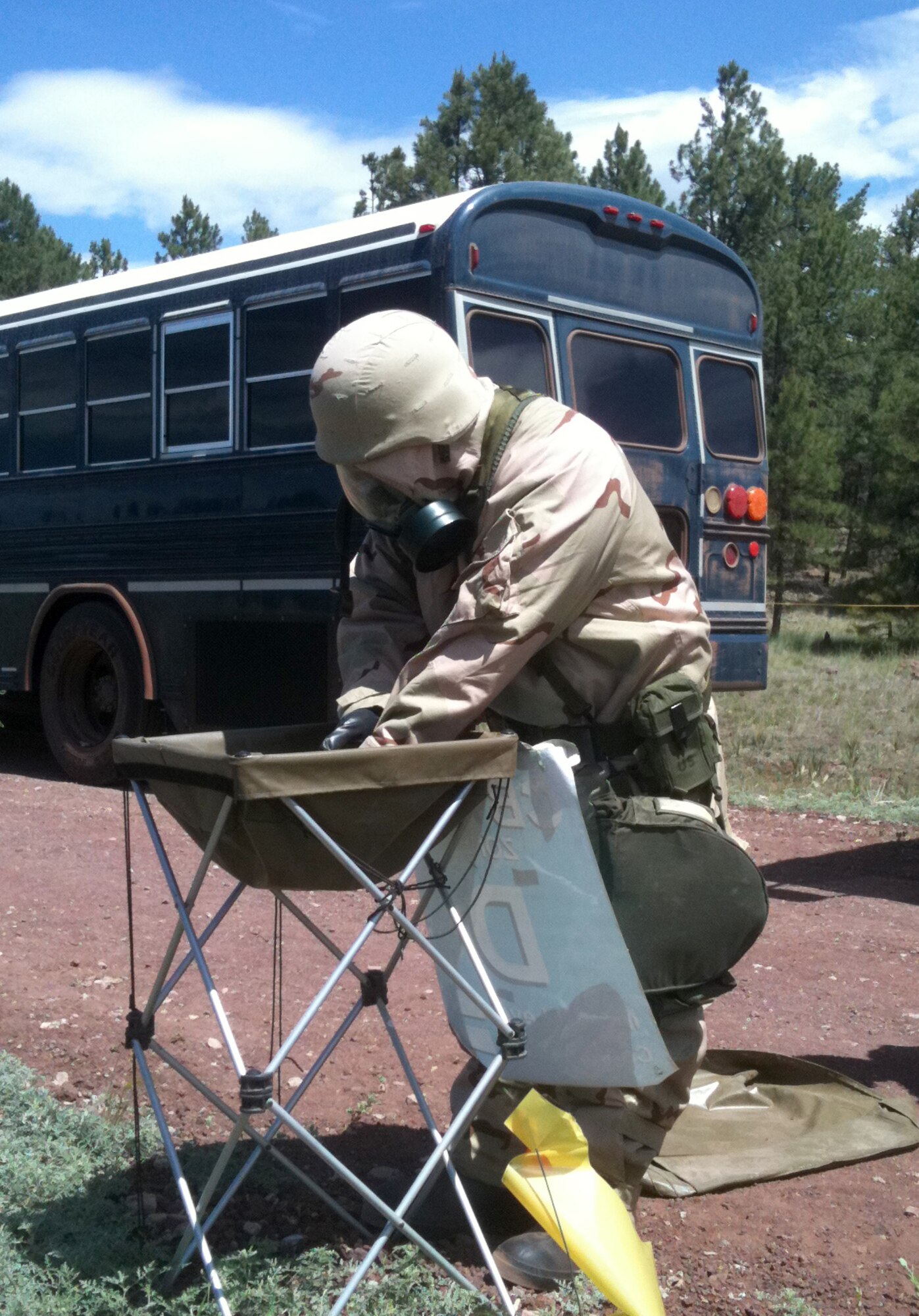 A mission support Airman decontaminates his hands after exiting a simulated contamination area. (U.S. Air Force photo/Lt. Col. Garry Beauregard)