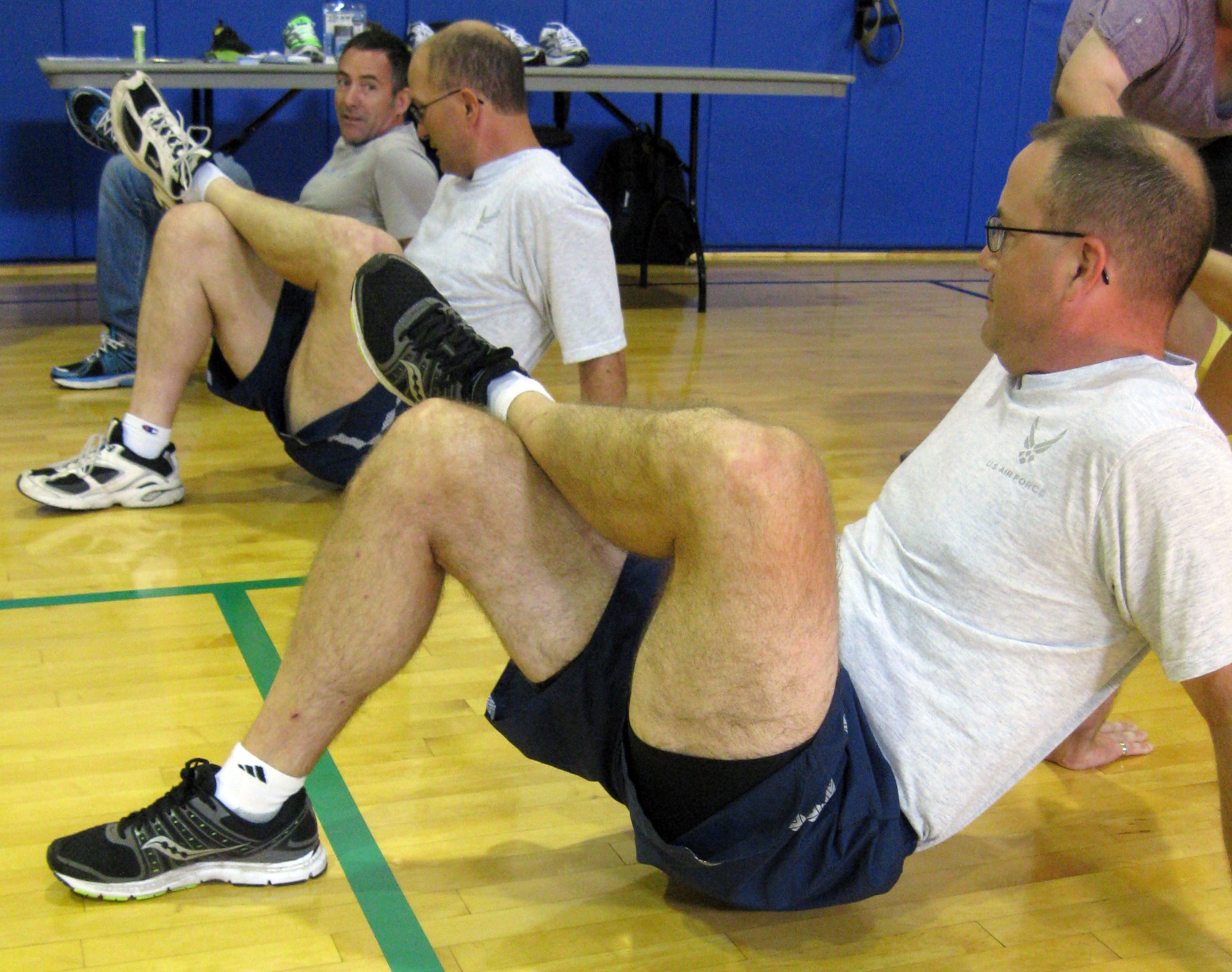 GRISSOM AIR RESERVE BASE, Ind. -- Ashley Johnson, top, a running consultant, offers some stretching ideas to Airmen during a running clinic held at the base fitness center on Aug. 6. Unit members had an opportunity to learn techniques to help them improve their running times and running efficiency during the clinic. (U.S. Air Force photo/Tech. Sgt. Douglas Hays)