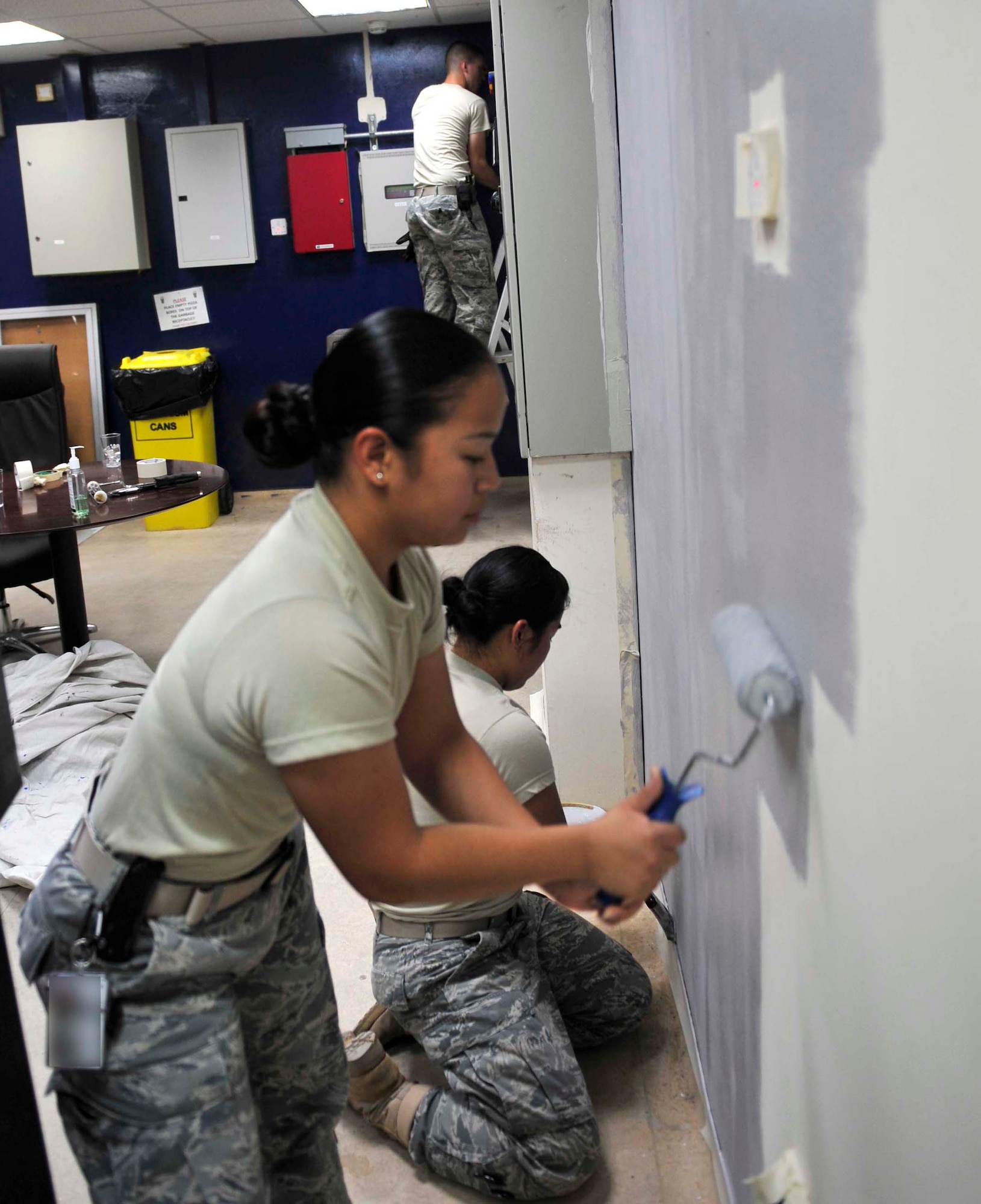 Airmen from the 380th Expeditionary Force Support Squadron paint walls of the Chapman Activity Center as part of a renovation project Aug. 6, 2011. The staff of the CAC is in the final stages of a remodeling project that will provide a more relaxing atmosphere for deployed Airmen and Soldiers at 380th Air Expeditionary Wing and will give folks more morale and welfare opportunities. (U.S. Air Force photo/Staff Sgt. Patrick Mitchell)