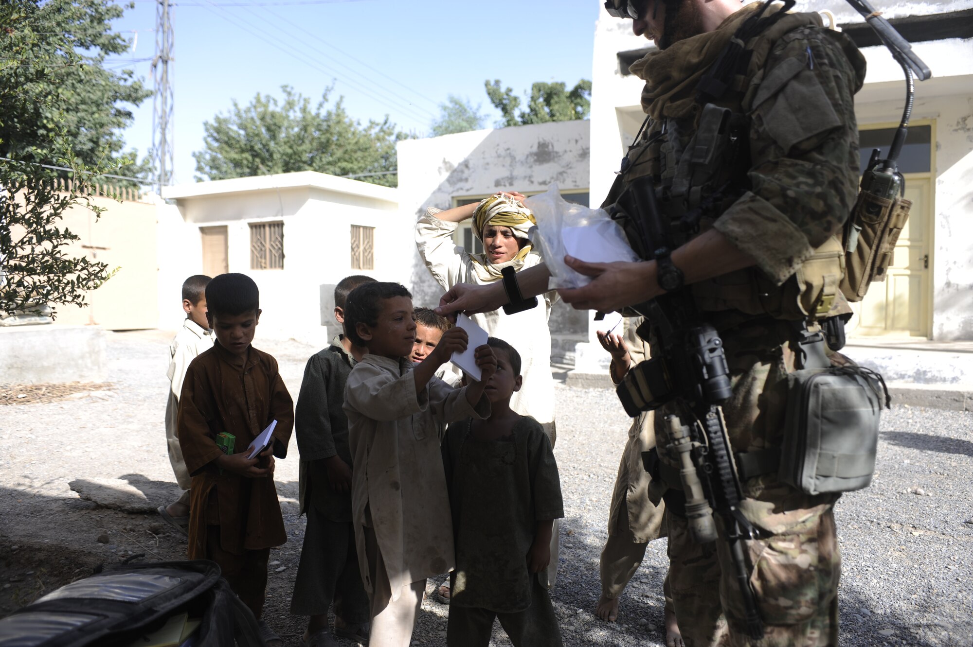 AFGHANISTAN -- Young children in a remote village receive school supplies. (U.S. Air Force photo by 1st Lt. Abigail Wise/Released)