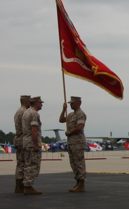 Sgt. Maj. Clark J. Rhiel, the squadron sergeant major for Marine Aerial Refueler Transport Squadron 452, passes the unit colors to Lt. Col. Kurt W. Stein during the change of command here Aug. 6, 2011. (Official U.S. Marine Corps Photo by Sgt. Timothy Parish) (Released)