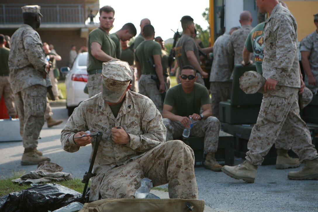 Cpl. Larve K. Wisner, a high-mobility artillery rocket system operator with 2nd Battalion, 14th Marines, 4th Marine Division, cleans his weapon aboard Marine Corps Base Camp Lejeune N.C., , Aug. 7, 2011, after returning from a deployment to Helmand Province, Afghanistan.  2/14 fired approximately 93 rockets in support of various Marine units.