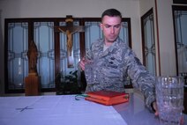 KUNSAN AIR BASE, Republic of Korea -- Tech. Sgt. Matthew Teets, the NCO in charge of Kunsan’s chapel, stages the altar here Aug. 4. In addition to their own faith, chaplain assistants are trained on religious pluralism -- a basic understanding of the world's major religions, including Christianity, Catholicism, Judaism, Islam and Buddhism. (U.S. Air Force photo/Master Sgt. Sonny Cohrs)