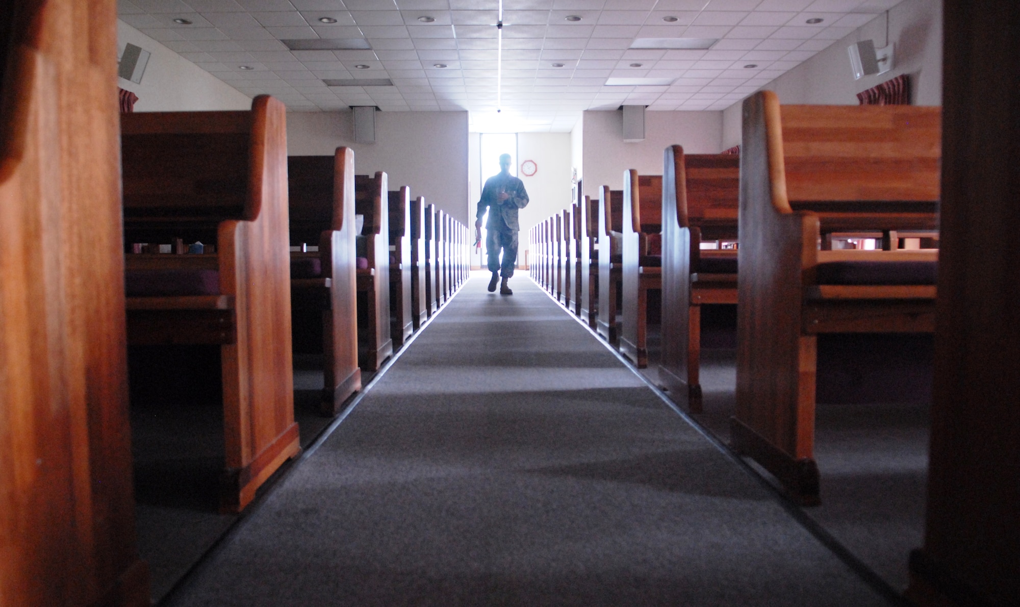 KUNSAN AIR BASE, Republic of Korea -- Tech. Sgt. Matthew Teets, the NCO in charge of Kunsan’s chapel, carries religious items through the sanctuary Aug. 4 to set up at the altar. In addition to their own faith, chaplain assistants are trained on religious pluralism -- a basic understanding of the world's major religions, including Christianity, Catholicism, Judaism, Islam and Buddhism. (U.S. Air Force photo/Master Sgt. Sonny Cohrs)
