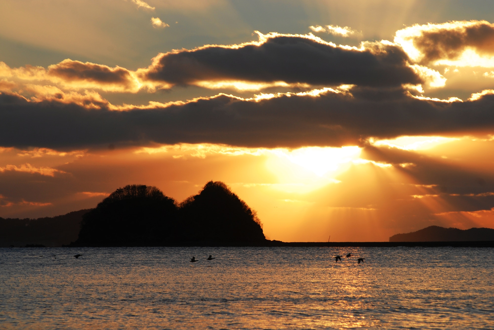 Birds fly over the water as sunset approaches near Gonam-ri, Republic of Korea. (U.S. Air Force photo/Staff Sgt. Eric Burks)