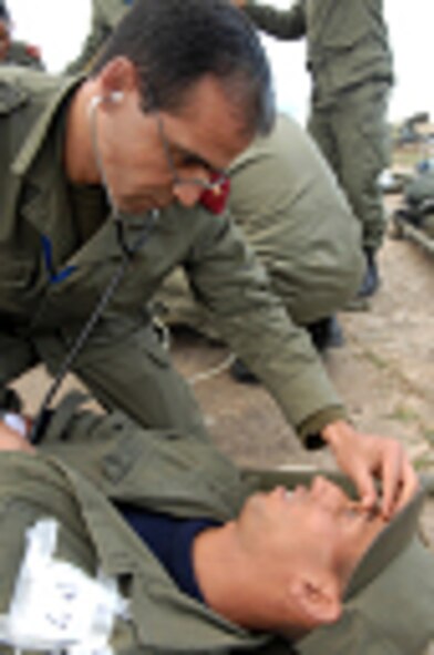 Tunisian Army doctor Capt. Mourad Guermit triages simulated patients as he observes for pupil response before critically injured patients are medically evacuated to a C-130 Hercules during a mock medical exercise at Kharrouba Air Base, Tunisia, Nov. 17, 2008 during Medlite 2008. Medlite is a Joint Chiefs of Staff Exercise designed to provide and exchange medical skills, techniques and procedures between members of the U.S. Air Force, U.S. Army and Tunisian Military Health Services. (U.S. Air Force photo by Senior Airman Erica Knight)
