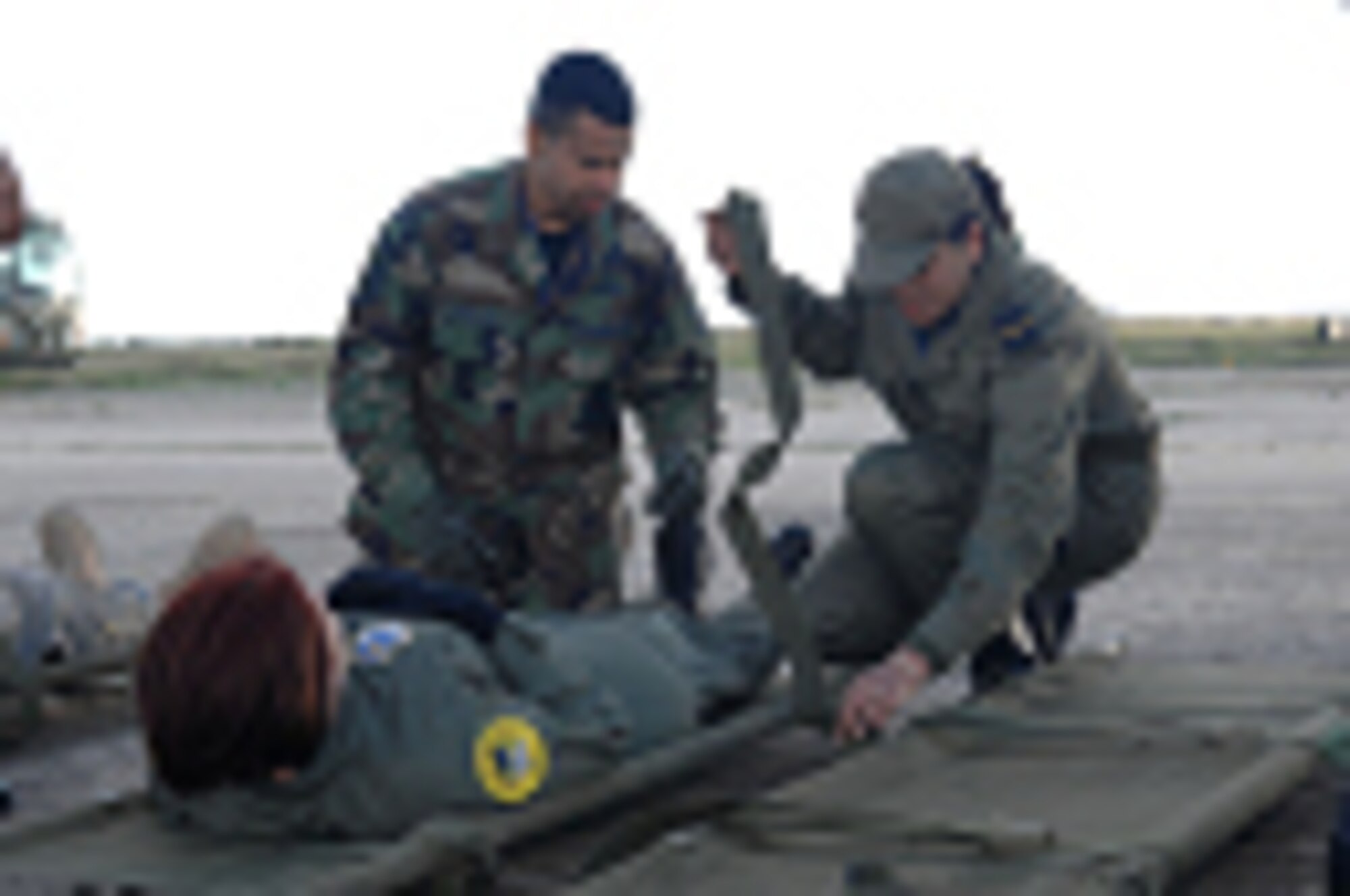 Senior Master Sergeant Anthony Hall III, left, a medical technician with the 349th Aeromedical Evacuation Squadron at Travis Air Force Base, Calif., shares patient litter securing techniques with Air Force and Tunisian Army personnel during Medlite 2008, at Kharrouba Air Base, Tunisia, Nov. 14, 2008. Medlite 2008 is a joint nations medical field training exercise between U.S. Air Force and Army medical personnel and the Tunisian Army. (U.S. Air Force photo by Senior Master Sergeant Kim Allain)