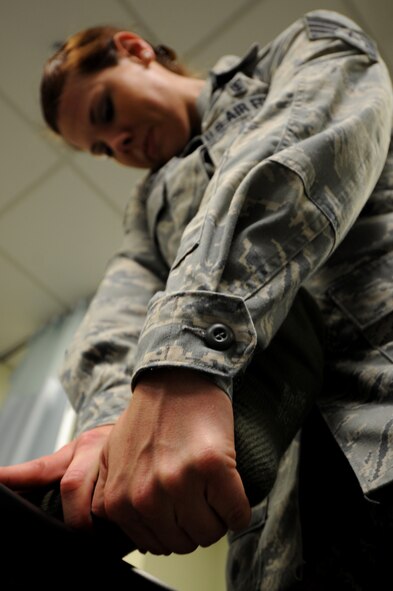 KUNSAN AIR BASE, Republic of Korea -- Staff Sgt. Carrie Merced, 8th Medical Operations Squadron, physical medical technician, massages a patient's ankle during a physical therapy session here on Aug. 4. She sees patients daily assisting them with the exercises to help strengthen and improve mobility to area ofa patient's injury. (U.S. Air Force photo by Staff Sgt. Rasheen DouglasReleased)