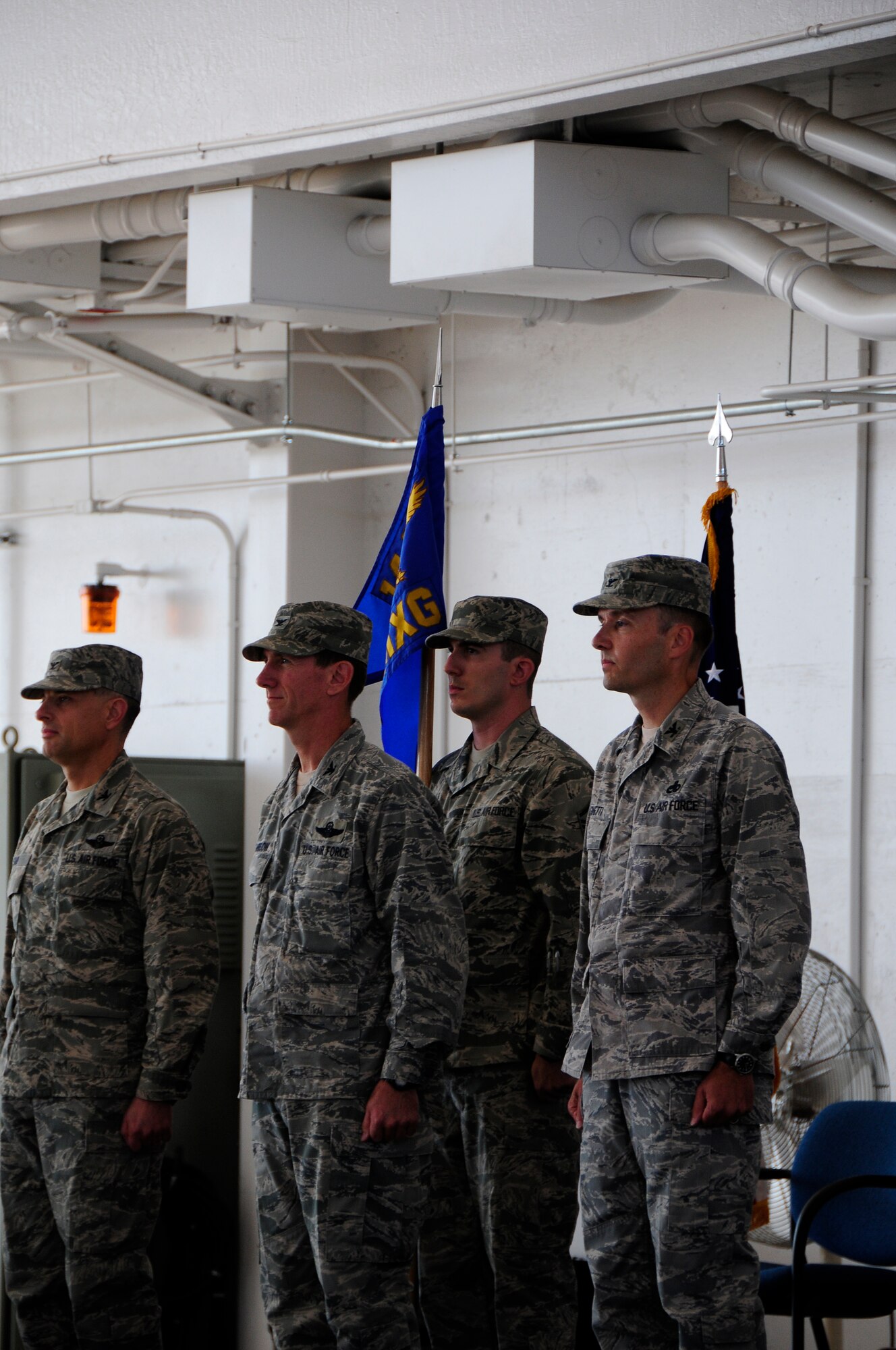 Col. Sami Said, 144th Fighter Wing Commander, along with Col. Clay Garrison and Col. Mark Favetti prepare for the exchange of the group guidon during the 144th Maintenace groups change of command ceremony. Col. Mark Favetti assumed  command of the 144th Maintenance group from col. Garrison during the ceremony August 7 2011.