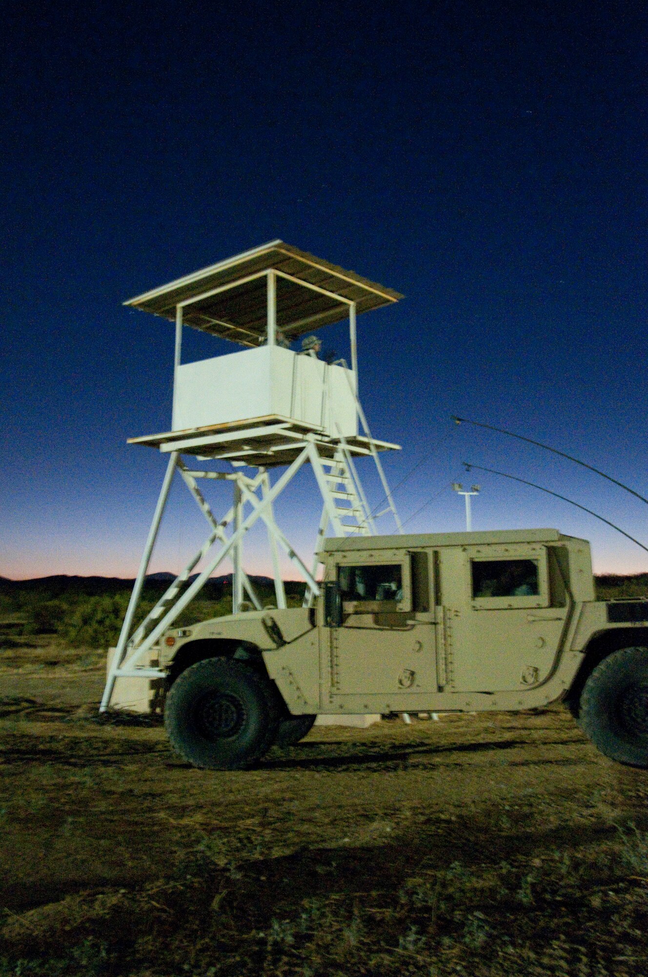 Members of the 144th Security Forces Squadron stand guard in a observation tower while taking part in a field training exercise at Camp Corum, Edwards Air Force Base, Calif. on Aug 4, 2011.  The Security Forces Squadron exercised at a training site deep into the Mojave Desert for the five day engagement which focused on night operations. (U.S. Air Force photo by MSgt. David J. Loeffler)