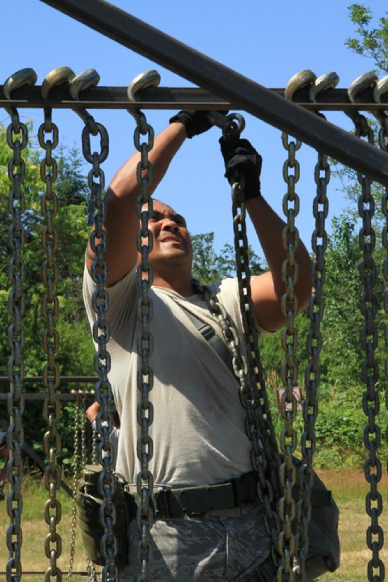48th Aerial Port team member Master Sgt. Sean Concepcion navigates a chain obstacle of the four-mile Aerial Port Challenge obstacle course during the Air Mobility Rodeo 2011 held July 24-29 at Joint Base Lewis-McChord, Wash. The 48th APS is part of the 624th Regional Support Group headquartered at Joint Base Pearl Harbor-Hickam, Hawaii. (U.S. Air Force photo/Master Sgt. Peter Rieta)