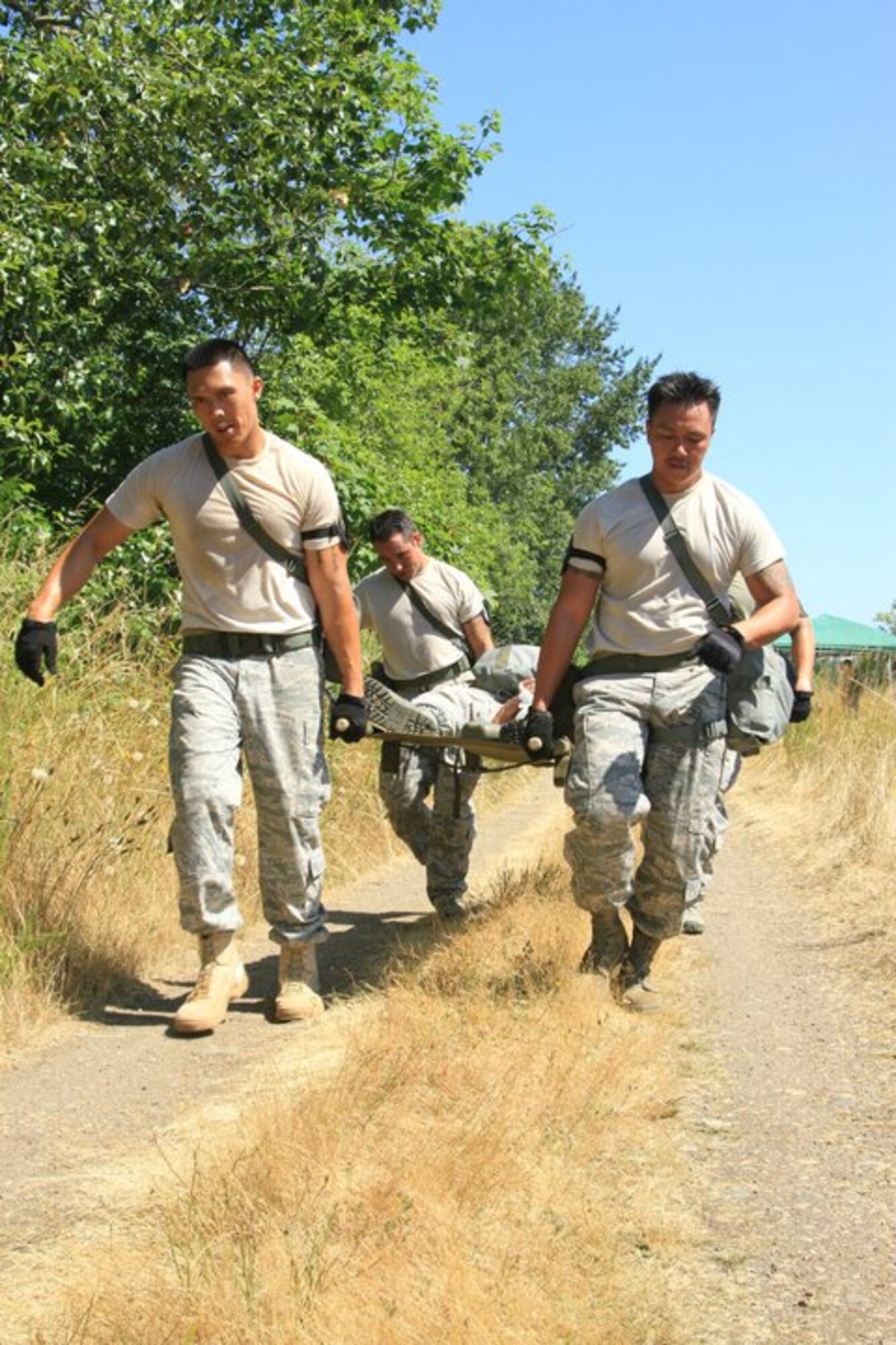 48th Aerial Port team members navigate a litter through the Self Aid and Buddy Care portion of the four-mile Aerial Port Challenge obstacle course during the Air Mobility Rodeo 2011 held July 24-29 at Joint Base Lewis-McChord, Wash. The 48th APS is part of the 624th Regional Support Group headquartered at Joint Base Pearl Harbor-Hickam, Hawaii. (U.S. Air Force photo/Master Sgt. Peter Rieta)