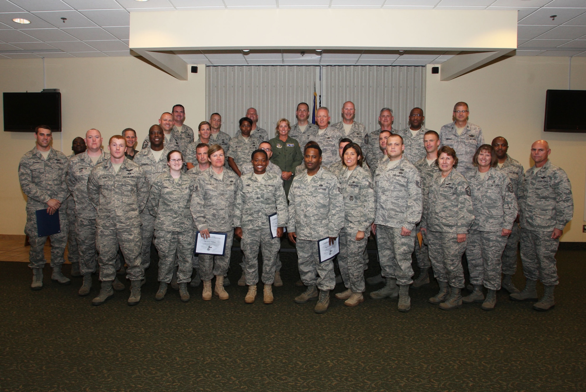 Commanders, supervisors, friends and families gathered together to congratulate the recent graduates of the Noncommissioned Officer Leadership Development Course here Aug. 5. (U.S. Air Force Photo/Don Peek)
