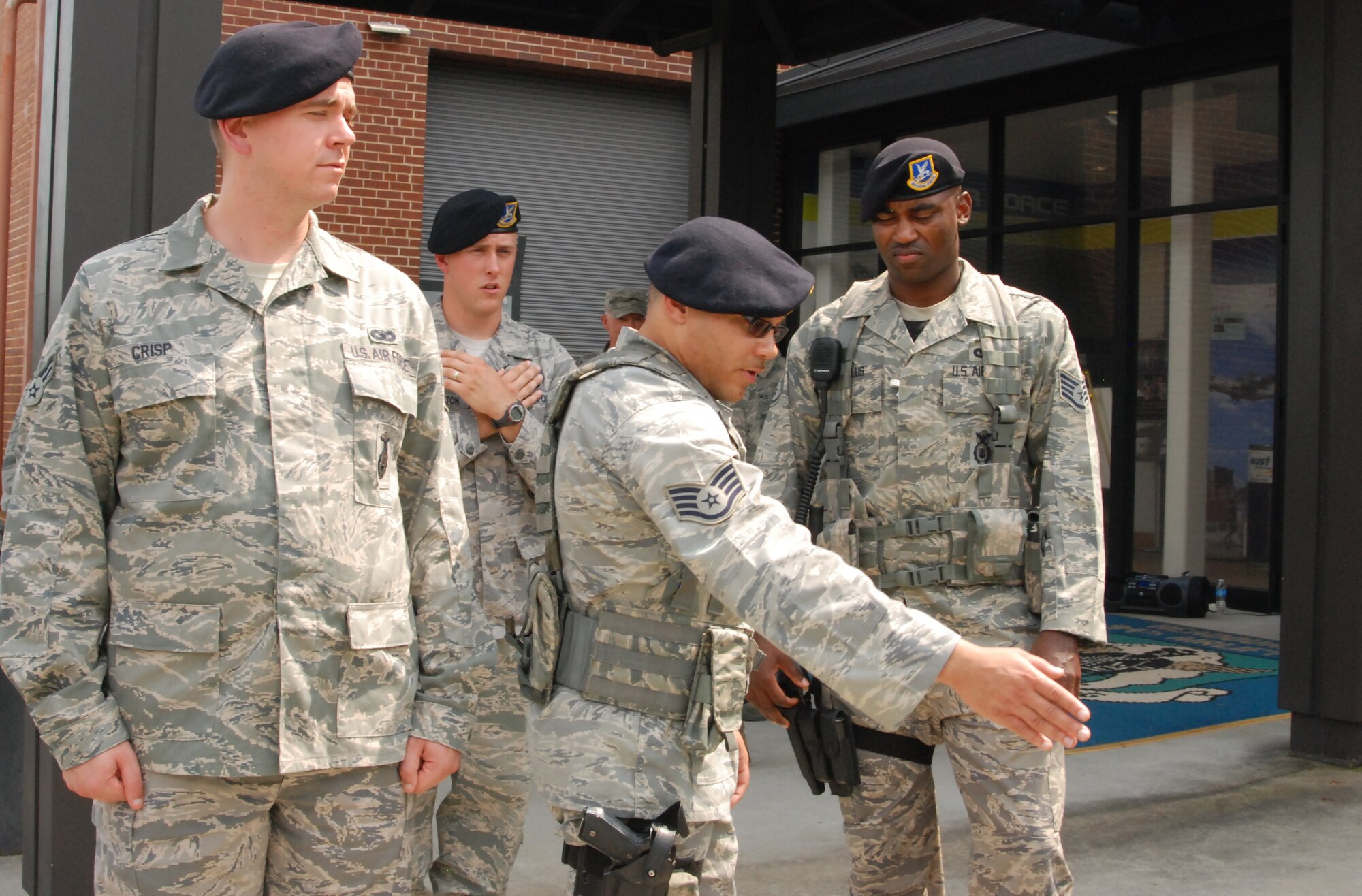 Service members from the 94th Airlift Wing security forces squadron here practice ceremonial procedures before Retreat Aug. 6 at the entrance of building 838. Retreat is a ceremony that serves to pay respect to the flag and signal the end of the duty day. Service members position themselves below the flagstaff to practice flag retrieval and folding. (U.S. Air Force photo/Airman 1st Class Chelsea Smith)