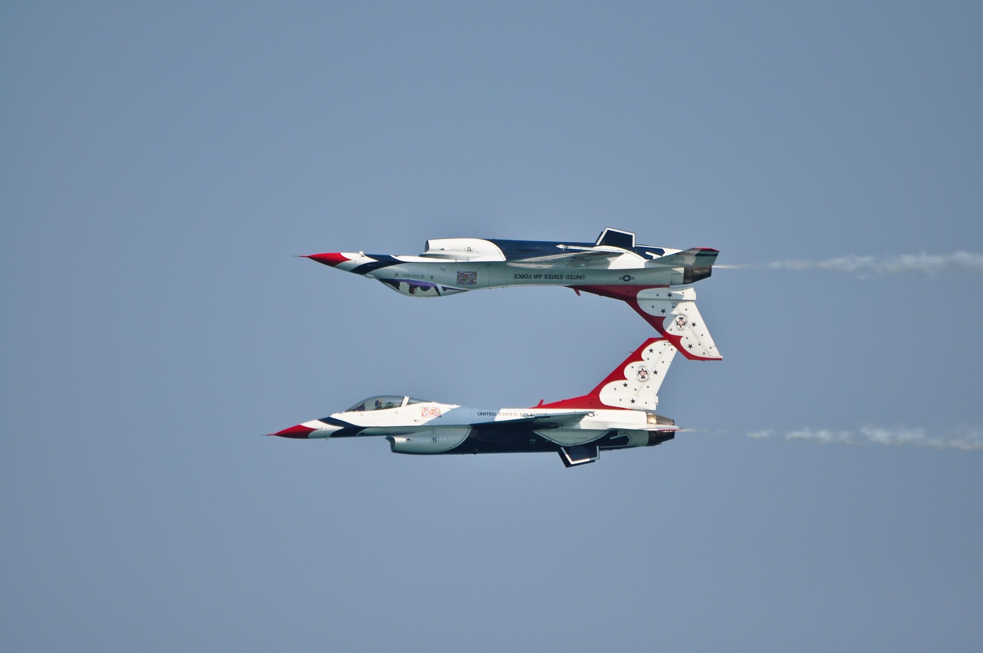 Thunderbird 5 flies inverted over Thunderbird 6 during the Milwaukee Air and Water Show on Saturday, August 6, 2011.  The Thunderbirds participated during the weekend air show, and they performed maintenance and preparation operations at the 128th Air Refueling Wing, Gen. Mitchell International Airport, Milwaukee.  (U.S. Air Force photo by Staff Sgt. Jeremy Wilson / Released)