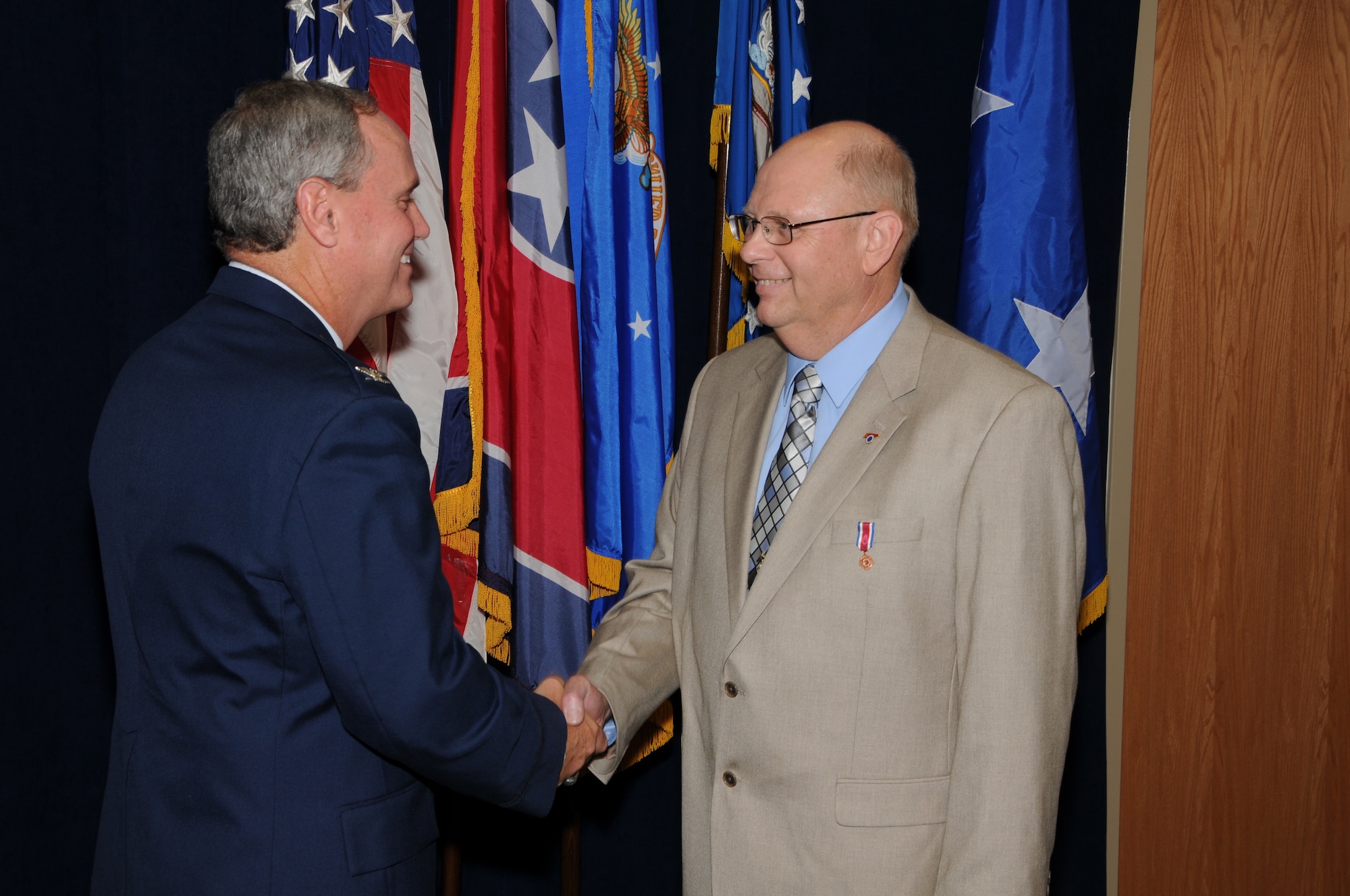 Colonel Harry D. Montgomery, 164th Airlift Wing Commander, presents the Tennessee National Guard Distinguished Service Medal to Lieutenant Colonel Lamar Spencer during Col Spencer's retirement ceremony.