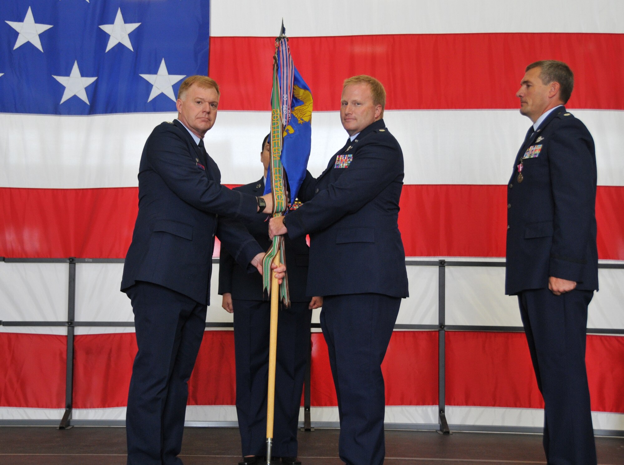 Lt. Col. Robert J. Hockman (center) assumes command of the 934th Operations Support Squadron during a change of command ceremony Aug 6.  Col. Ronald A Wilt (left), commander, 934 Operations Group officiated the ceremony.  Pictured far right is Lt. Col. Timothy W. Wollmuth, outgoing commander.