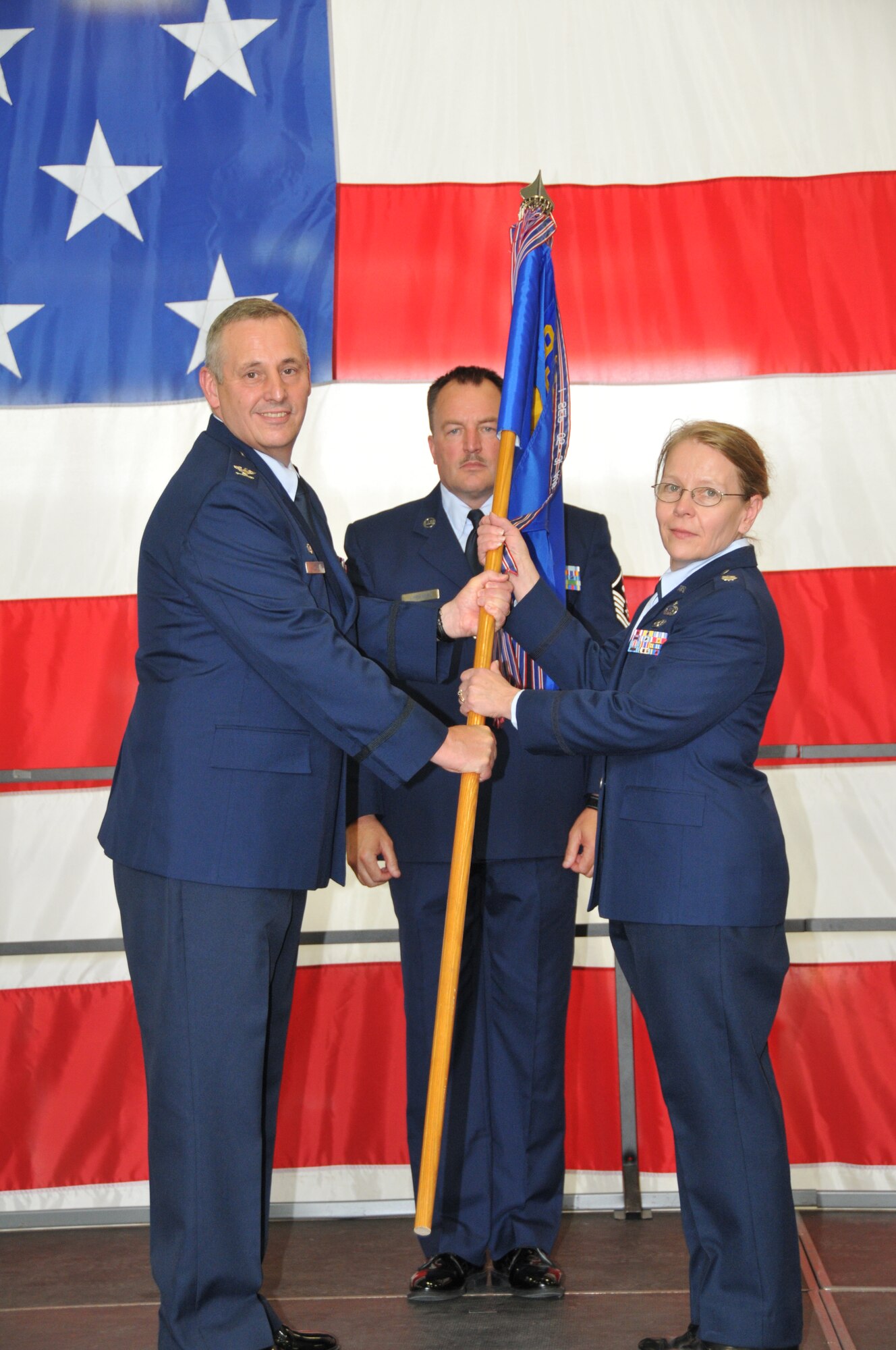 Lt. Col. Susan Maki (right) receives the 934 Force Support Squadron guidon from Col. Michael W. Ochs, commander, 934 Mission Support Group, as she assumes command of the squadron during a change of command ceremony Aug 6.