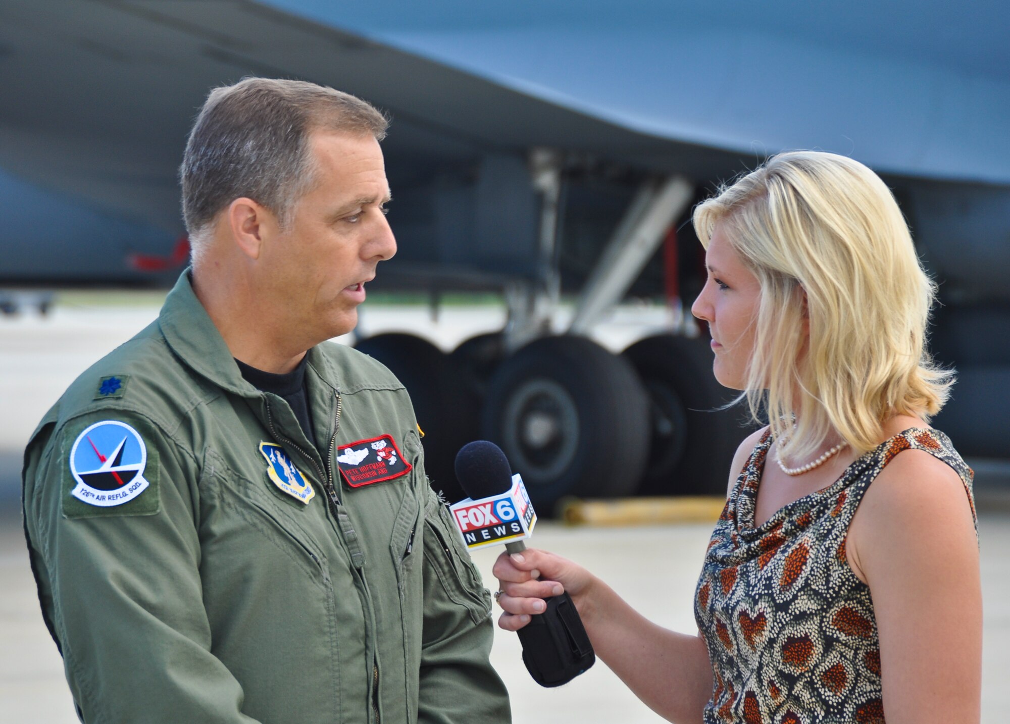 Lt. Col. Pete Hoffman, the 126th Air Refueling Squadron commander, discusses the 128th Air Refueling Wing's role in the Milwaukee Air and Water Show with Laura Langemo, an assignment reporter for Milawukee's Fox 6 News, on Saturday, August 6.  The 128th Air Refueling Wing hosted the Air Force Thunderbirds air demonstration team throughout the air show and provided support for the Las Vegas-based team.  The Thunderbirds' F-16C Falcons are home stationed at Nellis Air Force Base, Nevada, and they perform 70 shows per year with venues overseas and in the United States.  (U.S. Air Force photo by Staff Sgt. Jeremy Wilson / Released)