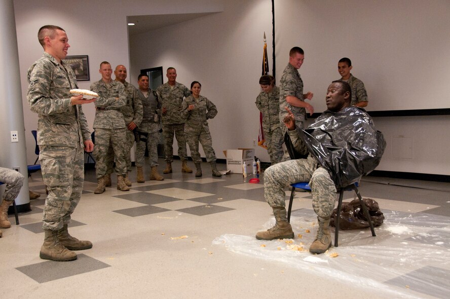 Chief Master Sgt. Bill Minter anticipates a pie in the face Aug. 6 from Airman 1st Class Michael Labreque. The 162nd Fighter Wing Junior Enlisted Council and wing senior leaders worked together on the “Pie in the Face” fund raising event to benefit several worthy JEC programs. (U.S. Air Force photo/Master Sgt. Dave Neve)