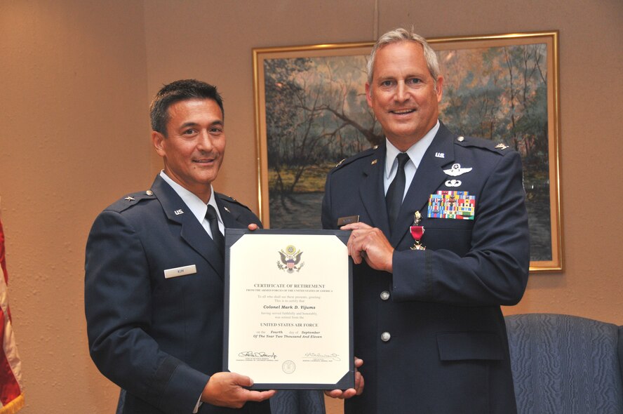 Brig. Gen Michael D. Kim presents the certificate of retirement to Col. Mark D. Vijums 934th Airlift Wing vice commander, Aug. 6.