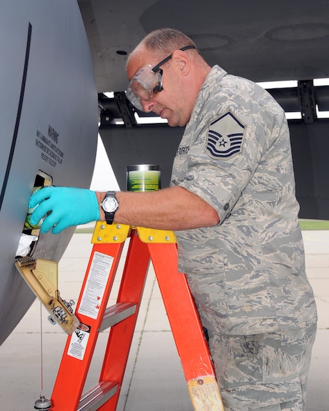 MSgt. Dave Larimer, 185 Air Refueling Wing (ARW), Sioux City, Iowa, adds oil to an engine on a KC-135R after a flight in Geilenkirchen, Germany on July 28.  Larimer and 37 other airmen deployed with two jets to give new NATO pilots the opportunity to get more experience with air-to-air refueling.