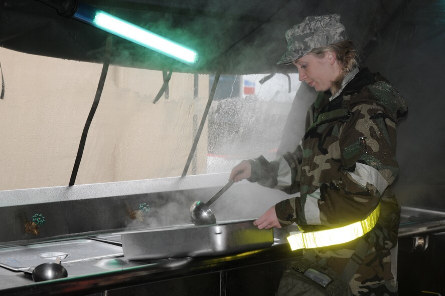 During Operational Readiness Exercise, "Operation Lightning Bug", Airman 1st Class Anna Rietveld, with the Services area of the 132nd Fighter Wing (132FW), Des Moines, Iowa works in the field kitchen at Volk Field, Wisconsin and prepares lunch on June 22, 2011.  The 132FW is in preparation for an Operational Readiness Inspection.  (US Air Force photo/Staff Sgt. Linda E. Kephart)(Released)