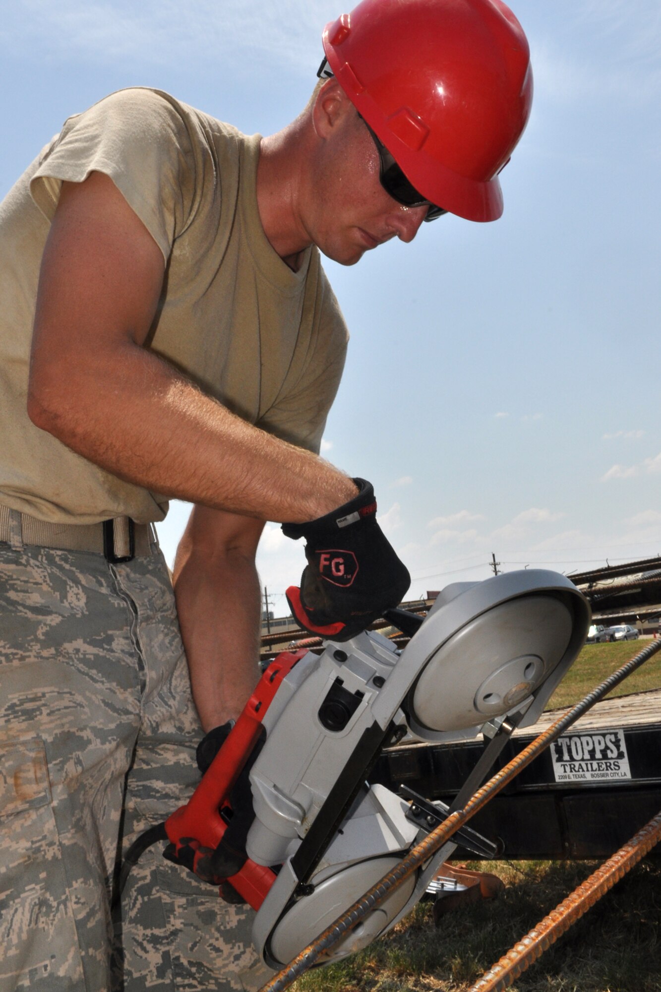Staff Sgt. Brian Dean, a carpenter with the 307th RED HORSE squadron, cuts a piece of rebar with portable band saw at Barksdale Air Force Base, La., Aug. 3, 2011. The Rapid Engineer Deployable Heavy Operations Repair Squadron Engineers (RED HORSE) Squadron was working on a construction project at the 93rd Bomb Squadron. (U.S. Air Force photo/Tech. Sgt. Jeff Walston) 

