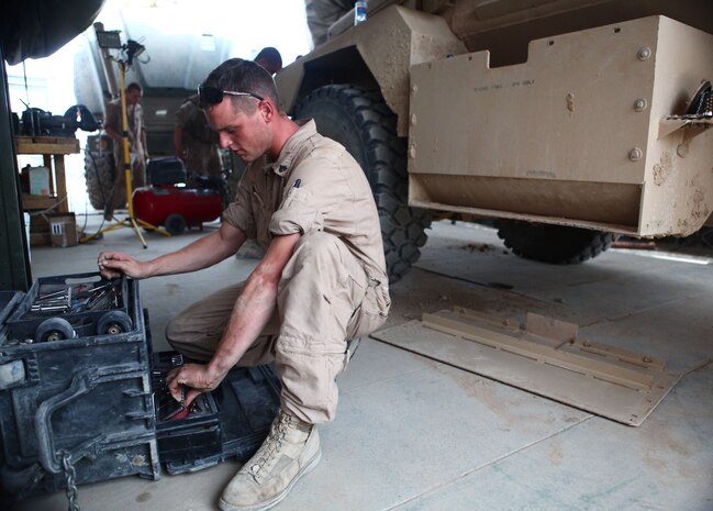 Cpl. Matthew Craven, quality control floor chief, Motor and Transportation section, 1st Battalion, 6th Marine Regiment, performs maintenance on a Mine Resistant Ambush Protected vehicle, here, Aug. 8. The Marines of Motor T are responsible for resupply operations in the area, as well as the maintenance and upkeep of all vehicles within the battalion.