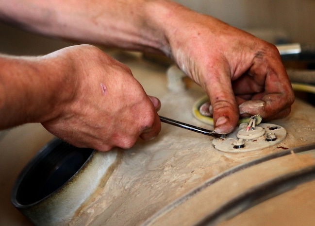 A Marine with Motor and Transportation section, Headquarters and Service Company, 1st Battalion, 6th Marine Regiment, performs maintenance on a Mine Resistant Ambush Protected vehicle, here, Aug. 8. The Marines of Motor T are responsible for resupply operations in the area, as well as the maintenance and upkeep of all vehicles within the battalion.