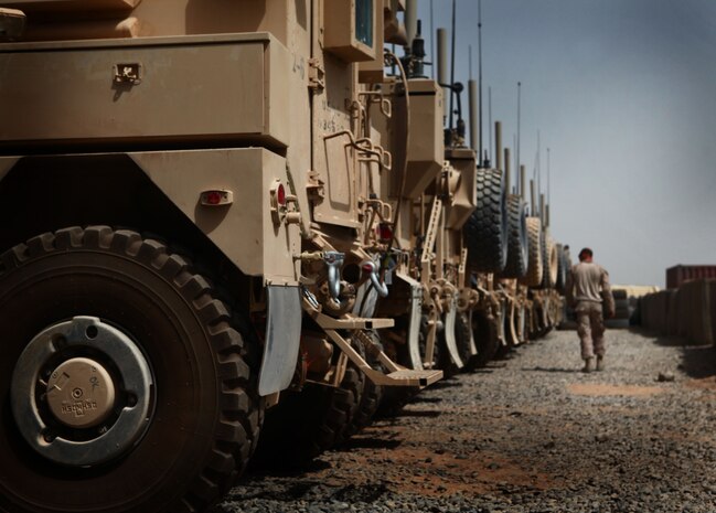 A Marine with the Motor and Transportation section, 1st Battalion, 6th Marine Regiment, makes his way through the motor pool here, Aug. 8. The Marines of Motor T are responsible for resupply operations in the area, as well as the maintenance and upkeep of all vehicles within the battalion.