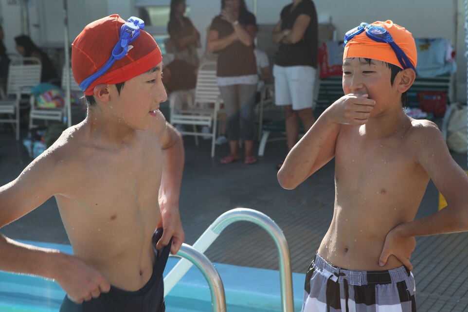 Boys from Oshima Island talk outside of the 25-meter pool on Marine Corps Base Camp Foster during a pool party, August 8. The event served as the culmination of a four day retreat and a continuation of the assistance received by the 31st Marine Expeditionary Unit during Operation Tomodachi. The 31st MEU is the only continually forward-deployed MEU, and remains the United States’ force-in-readiness in the Asia-Pacific region.