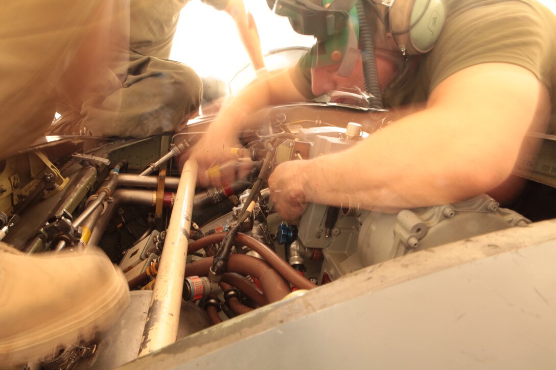 Staff Sgt. Luis Gonzales, a Marine Attack Squadron 513 avionics technician, helps replace a generator in one of the squadron’s AV-8B Harriers on the flightline of Kandahar Airfield, Afghanistan, Aug. 9.