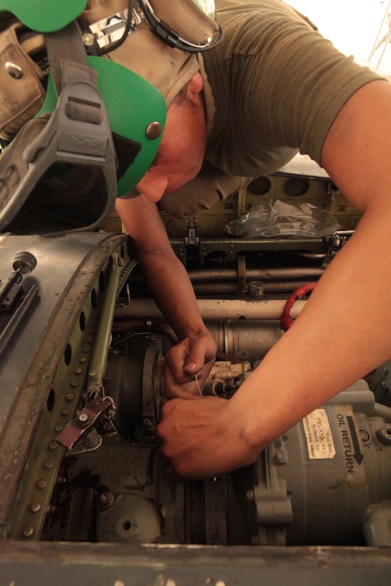 Cpl. Inez Pabian, a Marine Attack Squadron 513 avionics technician and Northridge, Calif., native, helps replace a generator in one of the squadron’s AV-8B Harriers on the flightline of Kandahar Airfield, Afghanistan, Aug. 9.