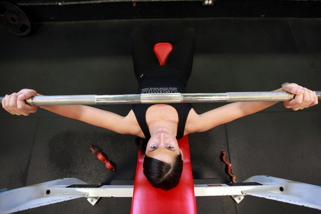 First Lieutenant Jennifer Silvers, the Marine Fighter Attack Squadron 122 material control officer, bench presses at the Air Station Fitness Center, Aug. 8. Silvers gets up every morning and does weightlifting in her at home gym for 45 minutes to an hour andwhen she's training for a competition she goes a second time.