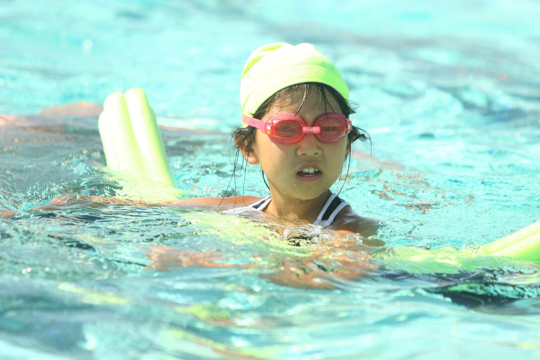 CAMP FOSTER, OKINAWA, Japan— A Student from Oshima district swims at a pool party held as part of a four-day cultural exchange program which took place Aug. 6-9. The Home-Stay Program was hosted by Marine Corps Bases Japan volunteer families for twenty-five students and five chaperones from Oshima District, Kesennuma City, Miyagi Prefecture, which was heavily damaged in the March 11 Great East Japan Earthquake. (U.S. Marine Corps Photo by Pfc. Brianna Turner/Released)
