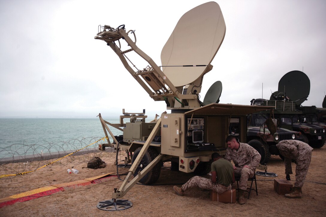 Marines with 7th Communication Battalion, III Marine Expeditionary Force Headquarters Group, III MEF, reestablish communications Aug. 8 for Exercise Ulchi Freedom Guardian following Typhoon Muifa. The equipment had been dismantled before the storm hit Okinawa Aug. 5.