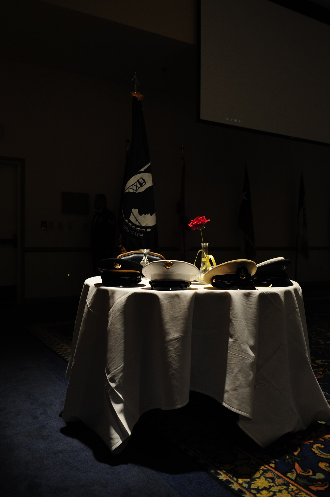 VANDENBERG AIR FORCE BASE, Calif. – The Prisoner of War table is illuminated during the POW/MIA ceremony honoring fallen or captured service members during the Senior Non-Commissioned Officer Induction Ceremony at the Pacific Coast Club here Friday, Aug. 5, 2011. (U.S. Air Force photo/Senior Airman Lael Huss)